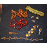 A cherry red amber coloured bead necklace, barrel clasp; others, silver cabochon bracelet,