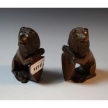 A pair of Anglo-Indian hardwood models, each carved as a lion supporting a shield, 11cm high, c.