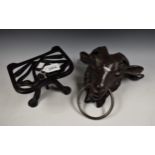 A novelty cast iron rams head door knocker; a Justryte cast iron trivet, reg.