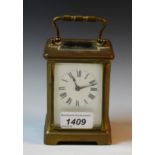 An early 20th century lacquered brass carriage timepiece