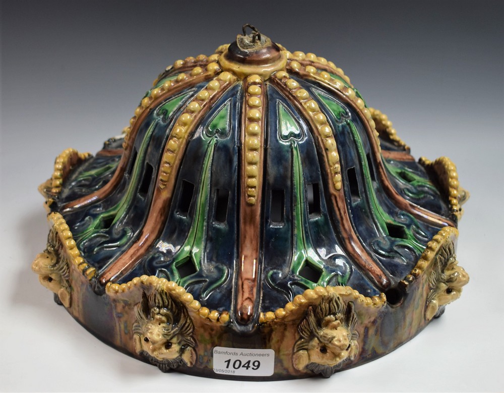 A Majolica ceiling light with lion mask rim