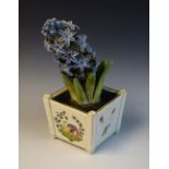 A continental model, of a Hyacinth in a tapering square pot,