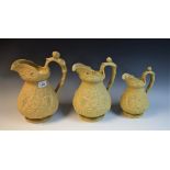 A set of three Victorian W Ridgeway & Co graduated biscuit glazed Bacchus jugs,