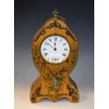 A balloon shape mantel timepiece, gilt metal mounted, the case printed with floral sprays,