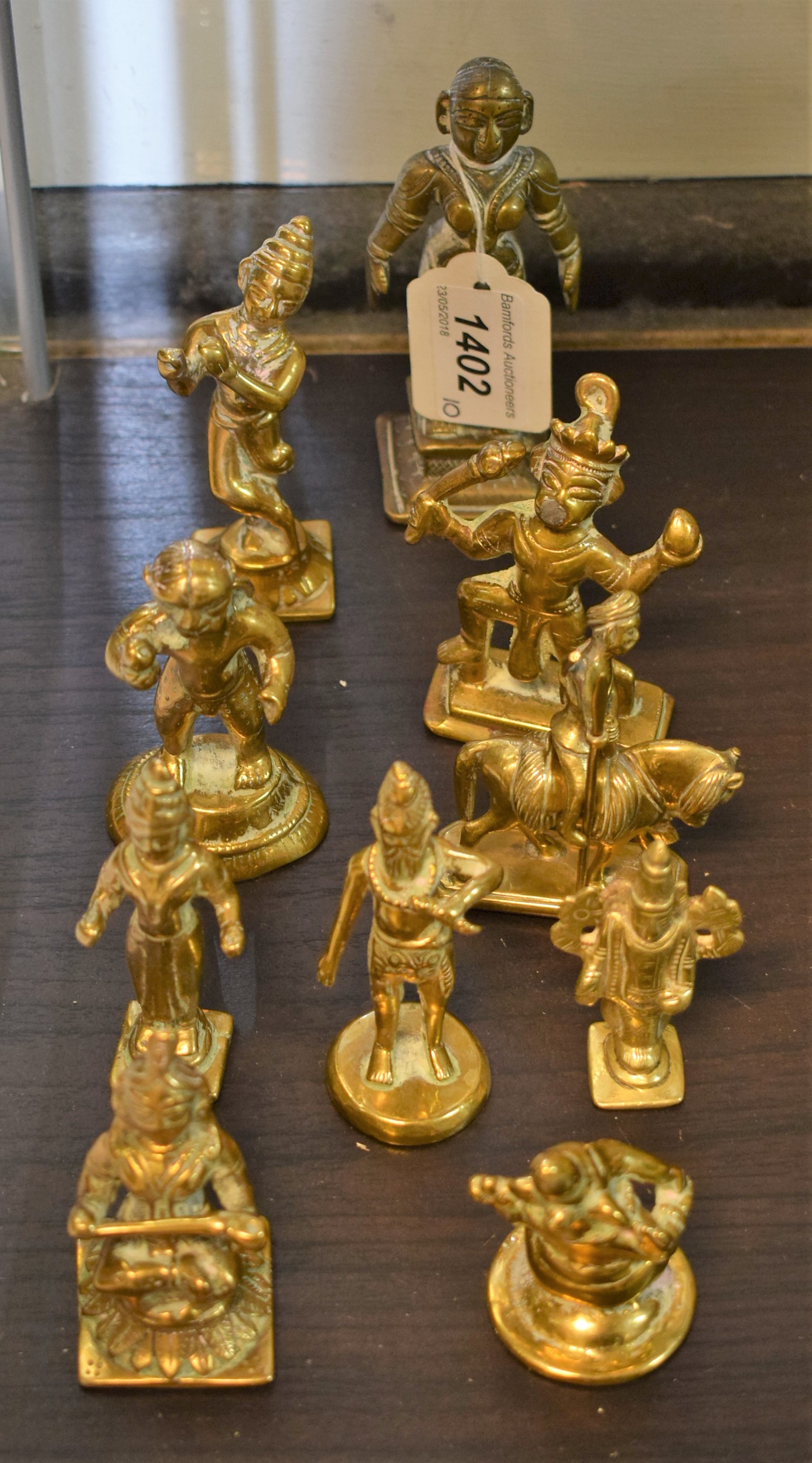An Indian brass domestic shrine figure, cast as a female deity, 11cm high; others,