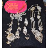 A white metal wedding suite, necklace, earrings and ring, open cast body, unmarked,