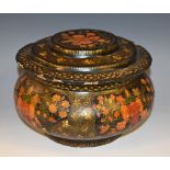 A Kashmiri papier mâché bowed circular box and cover, decorated overall with stylised flowers,
