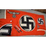 A Nazi German style flag, swastika emblem on red ground, 100cm x 160cm approx.