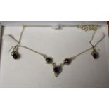 A sterling silver and amethyst necklace and earrings,