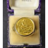 A gentleman's 9ct gold signet ring, set with a half sovereign dated 1912.