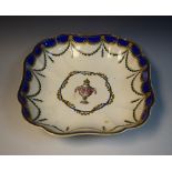 An 18th century Chelsea Derby shaped square bowl, Floral Urn centre, blue and gilt highlights,