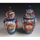 A pair of Imari vases and covers,