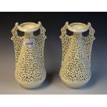 A pair of Graingers Worcester reticulated spreading ovoid vases, in the white,