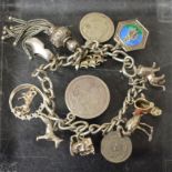 A silver charm bracelet, coins,