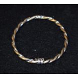 A 9ct gold two tone white and yellow twisting hinge bangle, stamped 375,