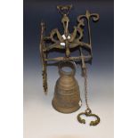 A cast brass church type wall mounting bell, cast ornate band beneath Latin script "Vocem meam audi,