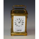 An early 20th century lacquered brass carriage timepiece, the enamel dial inscribed Wm.