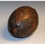 A 19th century carved coconut 'bug bear' flask,