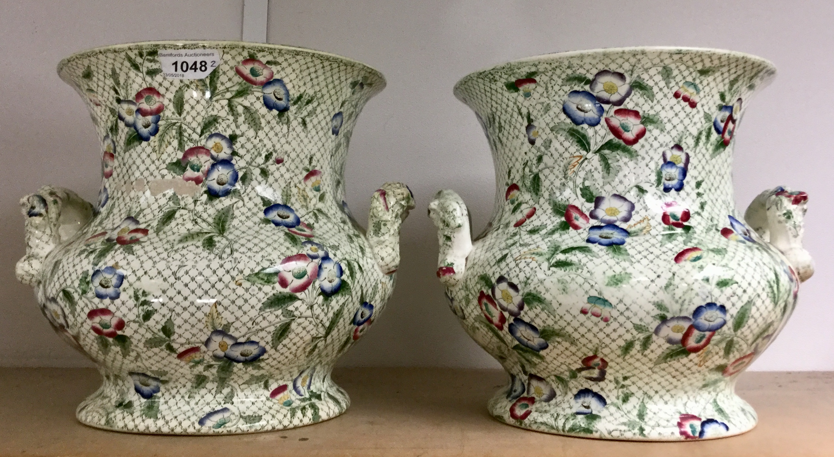 A pair of late 19th century two handled ogee pottery planters, printed with flowers, c.