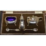 A Walker & Hall silver three piece cruet set, salt, mustard and pepper, with spoons, Chester 1938,