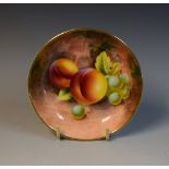 A Royal Worcester pin dish, signed, with ripe fruit on a mossy ground, 11cm diam,