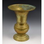 A Middle Eastern brass vase, of Chinese influence and gu shape, circular foot, 25.