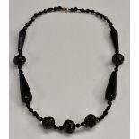 A Victorian carved jet bead necklace, composed of nine principle spiral and faceted beads,