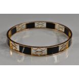 A 9ct gold and black onyx panelled slave bangle,