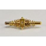 A Victorian diamond inset bar brooch, central diamond approx 0.