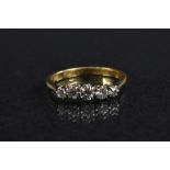 A graduated diamond five stone line ring, central round cut diamond approx 0.