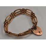 A 9ct rose gold fancy arched triple row gate-link bracelet, padlock clasp, stamped 9ct gold, 13g,