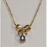 A diamond and pale blue topaz ribbon bow necklace,