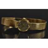 Tissot - a 9ct gold lady's bracelet wristwatch, silvered dial, block batons, black hands,