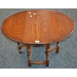 An Old Charm oak dropleaf occasional table, model 1493, oval top. 47.5cm high x 59.