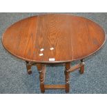 An Old Charm oak dropleaf occasional table, model 1493, oval top. 47.5cm high x 59.