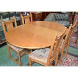 An oak Old Charm extending dining table and four chairs,