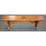 An oak bench, moulded rectangular top, shaped end supports. 46cm high x 137cm long x 27cm wide .