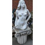 A reconstituted stone garden ornament - Cleopatra on an ionic style plinth.