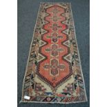 An Oriental carpet runner 9'6" x 2'8"