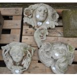 Three reconstituted stone mask wall pockets.