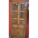 An Old Charm oak floor standing corner display cabinet, two three light doors to top,