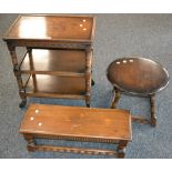 An oak three tier tea trolley; an oak occasional table, circular top; a Priory style low stool.