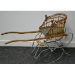 A Victorian dog cart, wicker work seat on wrought iron chassis.