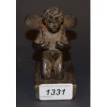 Continental School (19th century), a dark patinated bronze, of a kneeling putto,