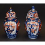 A pair of Imari vases and covers,