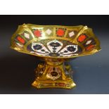 A Royal Crown Derby 1128 shaped square comport, all gold border, dolphins to angles, 30cm wide,