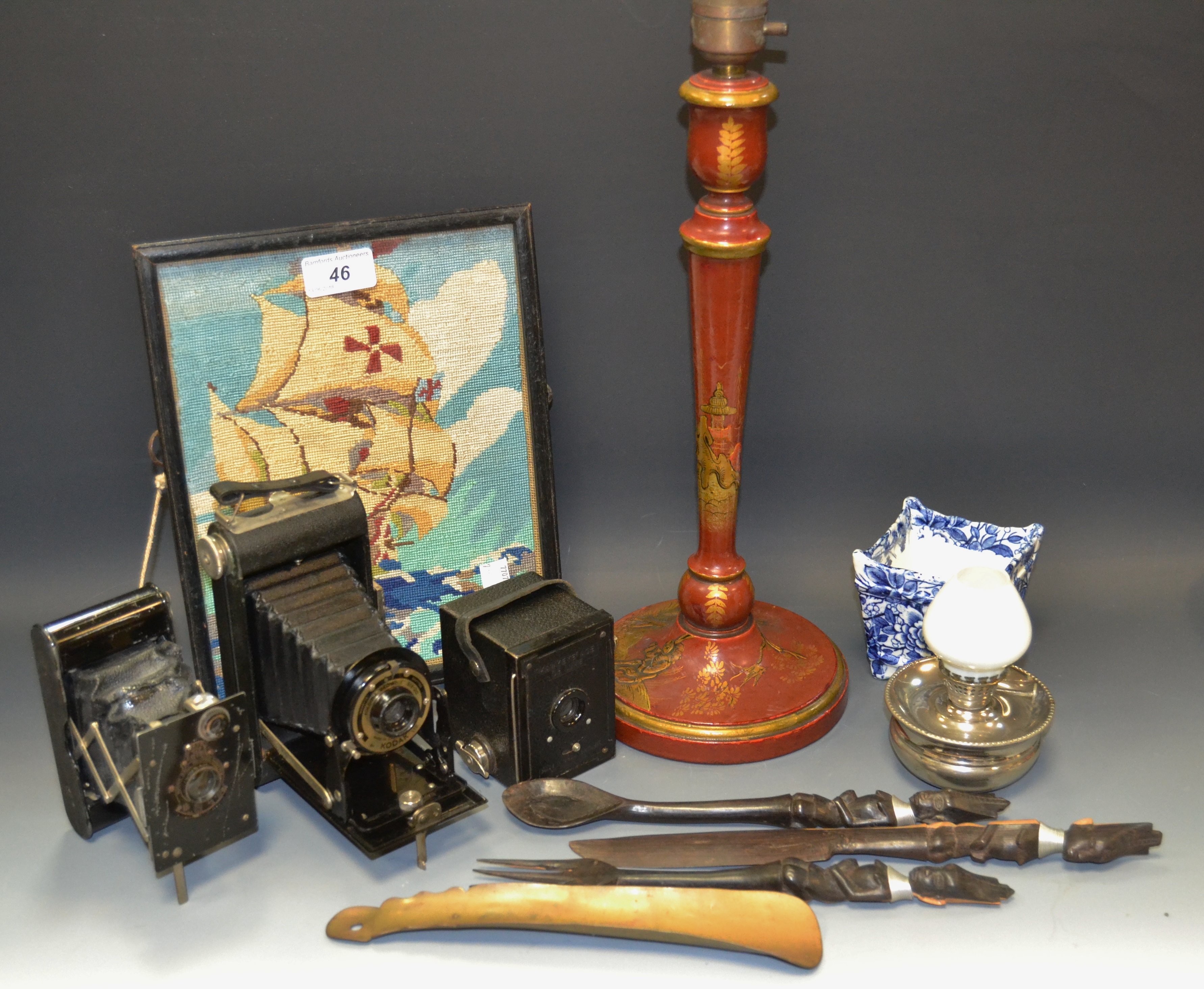 Cameras including Brownie; a table lamp; woolwork; African flatware;