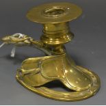 A 19th century brass novelty novelty chamber stick, cast as a saddle,