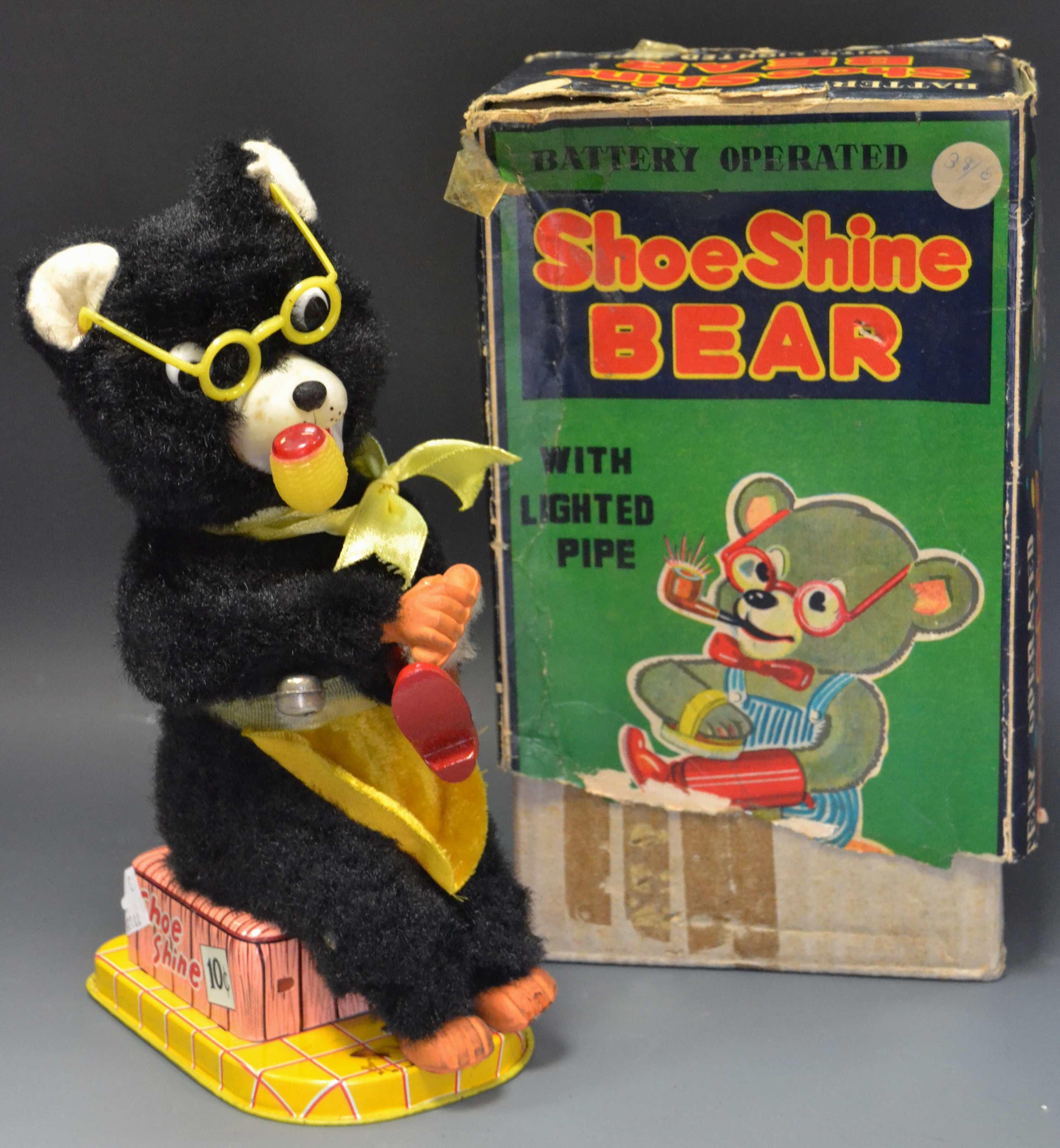 A tin plate battery operated shoe shine Bear