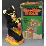 A tin plate battery operated shoe shine Bear